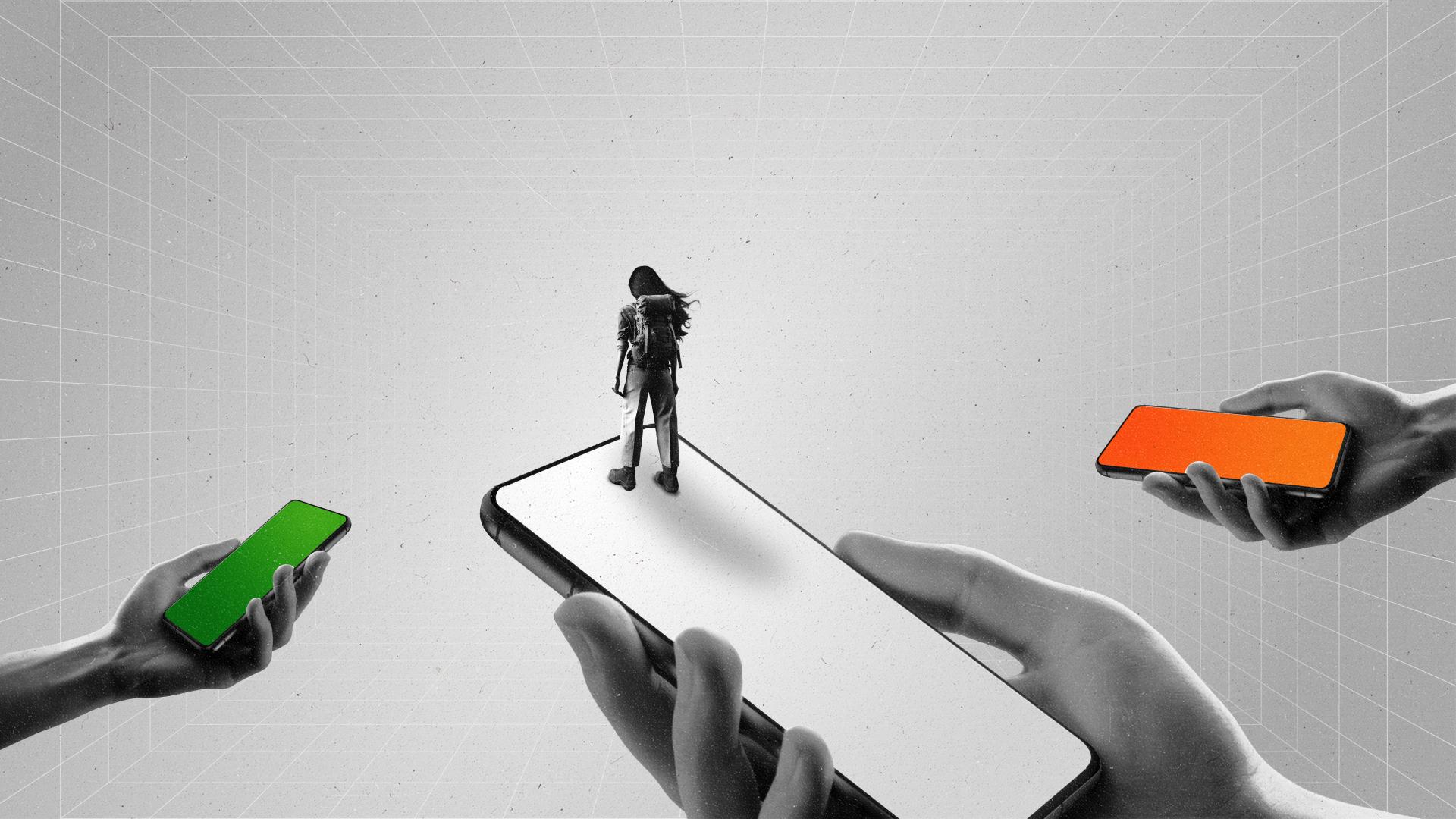 A woman looks out into the distance while standing on phones displaying the colors of the Indian flag.