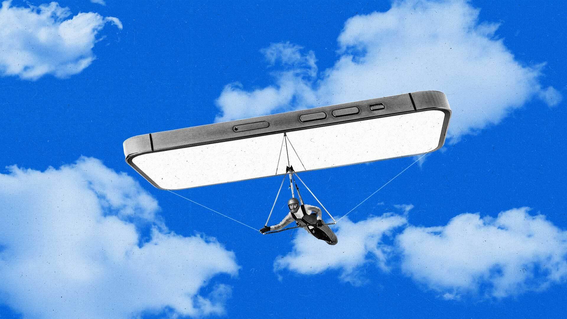 A man handglides with a smartphone through the sky.