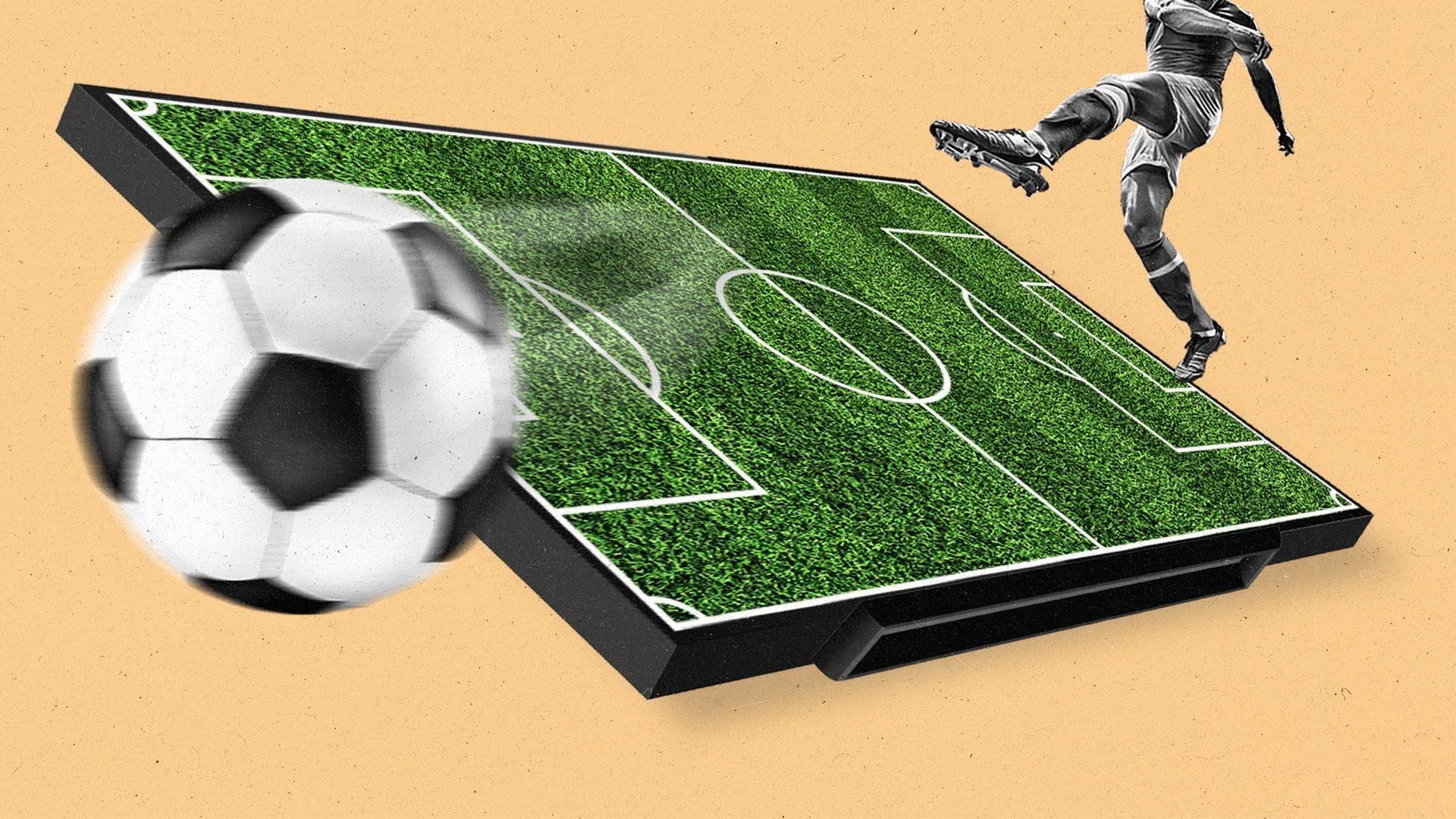 Soccer player kicks a ball over a green soccer field.