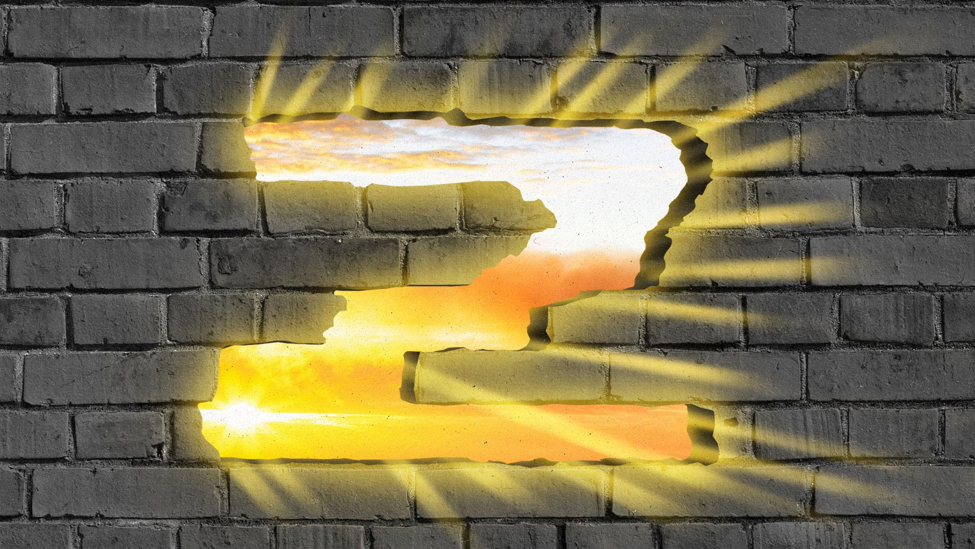 A golden Z-shaped hole in a brick wall glowing gold.